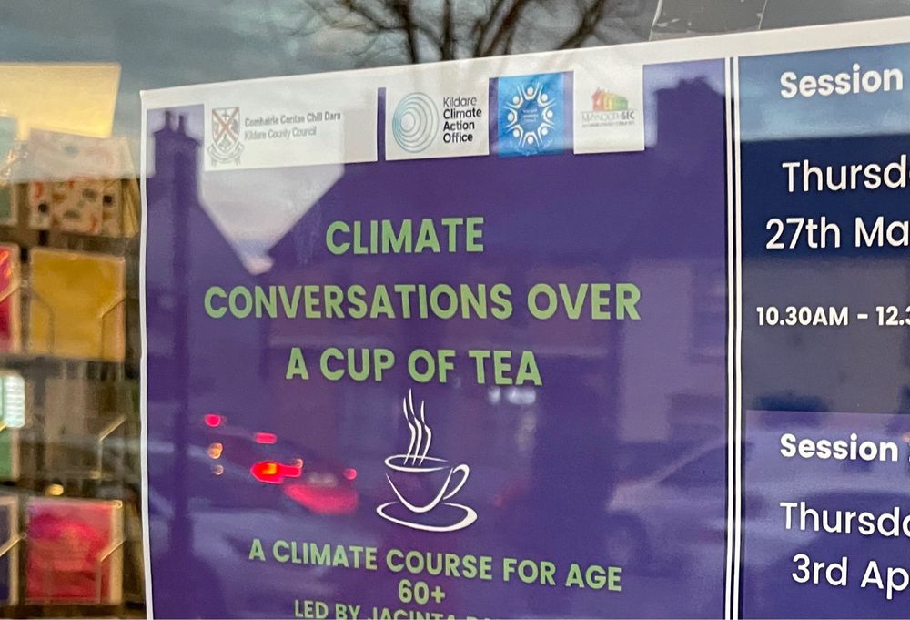 A window poster describing a ‘climate conversations over a cup of tea event’ for the local community 