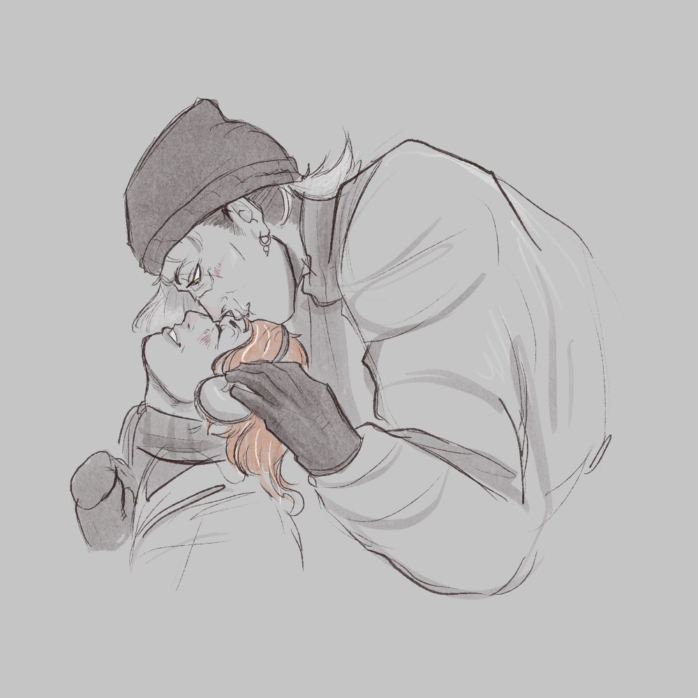 A much larger woman leans over an average height woman from behind, kissing her on the forehead. They are both wearing winter clothing.