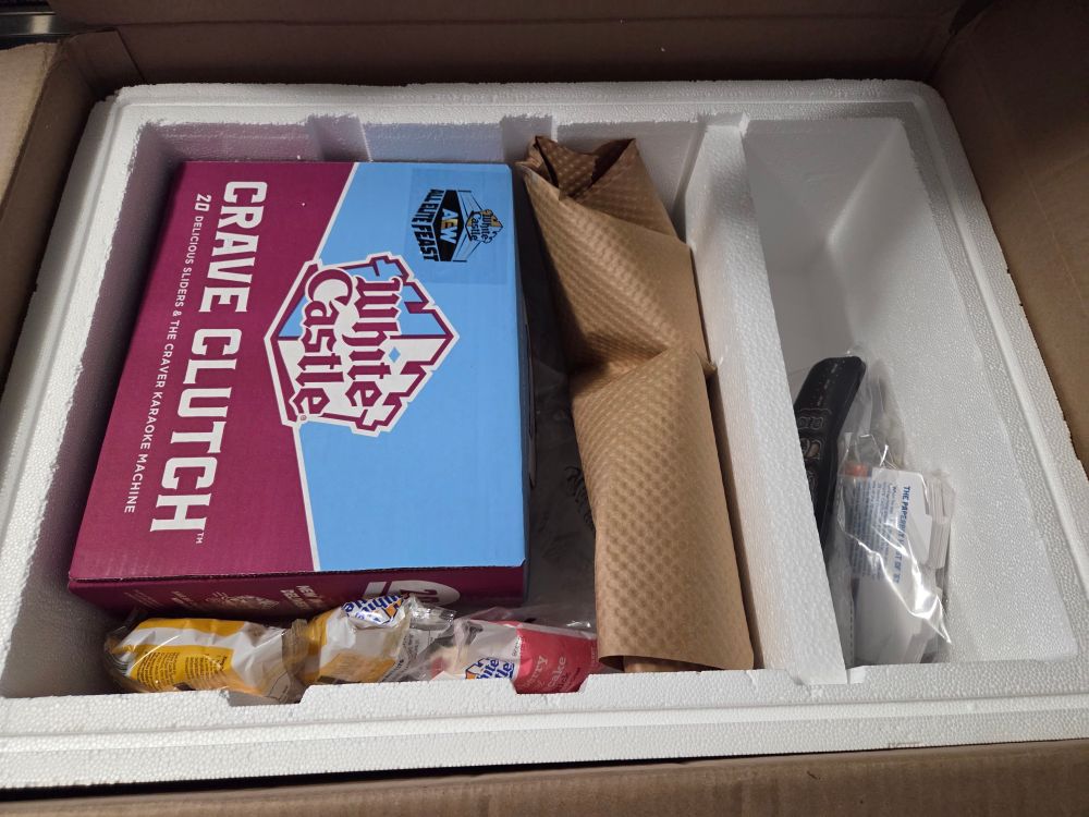 The Crave box with sliders inside. Desserts, pickles, and the merch items on the right side.