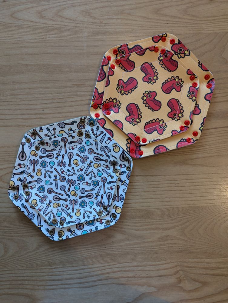 Two sizes of dice trays open and laying flat on a table in the Edinburgh board game shop Ancient Robot Games.
