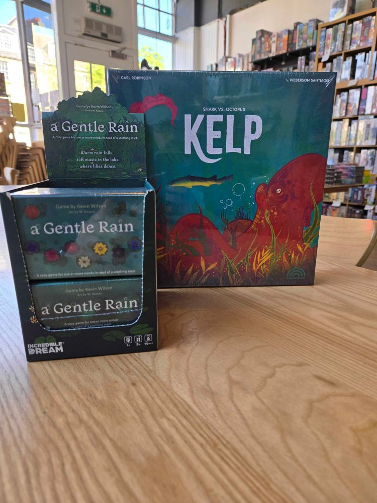 The games Kelp Shark vs Octopus and a Gentle Rain on a table in the Edinburgh board game shop Ancient Robot Games.