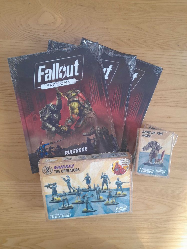 Fallout Factions Rulebook, The Operators minis and King of the park mini on a table in the Edinburgh board game shop Ancient Robot Games.