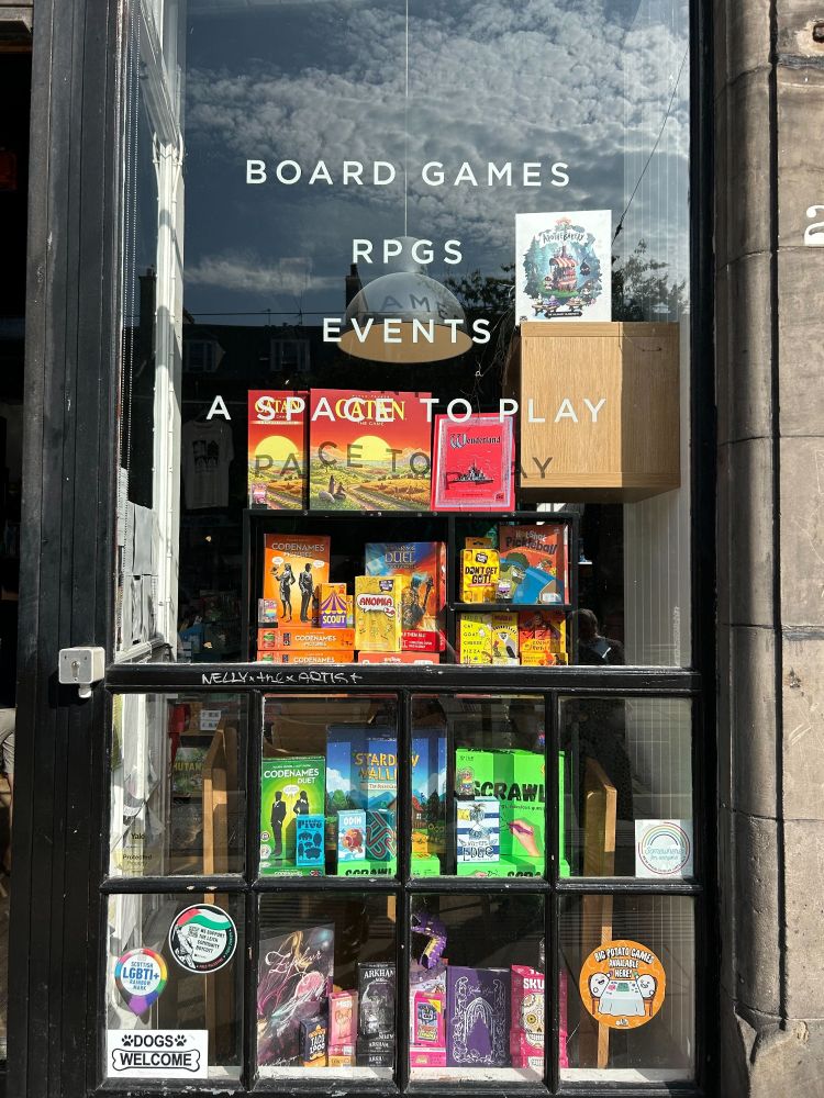 The board game shop Ancient Robot Games window display with board games in the different colours of the rainbow 