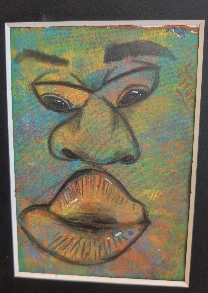 This image features a close-up, abstract portrait painted in vivid, layered colors. The artwork focuses on a distorted human face, arranged in a playful, exaggerated composition. The background is a vibrant, textured mix of greens, blues, oranges, and yellows with subtle stamped or stenciled patterns adding extra visual depth. Hints of red and purple peek through in places, creating a multicolored, organic texture that resembles sponged or layered acrylic.

The facial features are large and central, occupying nearly the whole canvas. The eyes are asymmetrical, almond-shaped, and outlined in black, with golden yellow and orange highlights on the lids and glints of white suggesting reflected light in the pupils. They are angled in a way that gives the face a curious, almost mischievous expression.

The nose is oversized and drawn in a highly stylized manner—broad, rounded, and almost triangular—resembling a caricature. It dominates the center of the piece, rendered with curved black lines and soft shading that gives it depth and presence.

Below the nose, full lips are painted with great emphasis. They are orange, red, and yellow with touches of green, blending into the background colors yet still standing out due to black contouring and highlights. The lips appear to be slightly parted and carry a sensual, almost pouty quality.

The eyebrows are thick and dark, arched unevenly above the eyes. They appear smudged or soft-edged, contributing to the expressive and surreal feel of the face.

The whole image is framed with a thin white border and mounted on a black background, giving the colorful portrait contrast and focus.

The style is expressive and experimental, combining elements of cartoon, abstraction, and street art. It evokes a sense of emotion and curiosity, leaving room for personal interpretation.