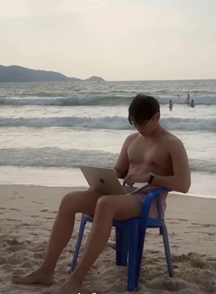 Mew shirtless on the beach again with a MacBook for some ad in a plastic chair like why is this happening think of the laptop!!! 
