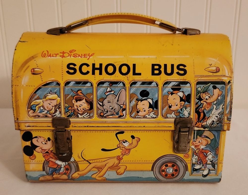 Lunch box with a Walt Disney School Bus design from the 1970s. Goofy is the bus driver and different characters are in the bus or getting on the bus.