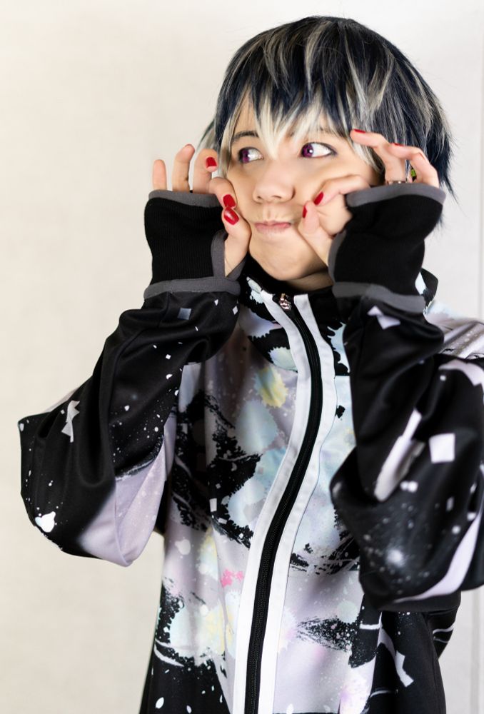 Me cosplaying as Momo from the group Re:vale wearing casual clothes. I form dangos with my fingers on my cheeks.