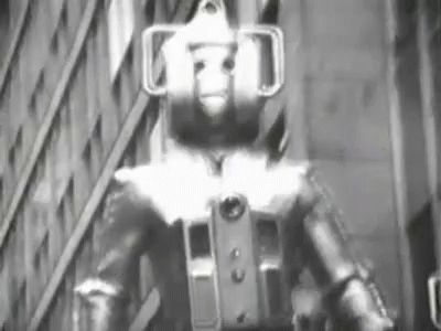 A 60s Cyberman marching through London, captioned "bite my shiny metal ass" 