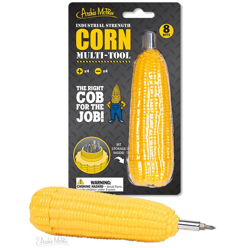 A corn-shaped multi-tool by Archie McPhee, featuring eight bits. The packaging states "Industrial Strength," and includes a drawing of a smiling corn cob wearing overalls. A real multi-tool in the shape of an ear of corn is shown in the foreground. 