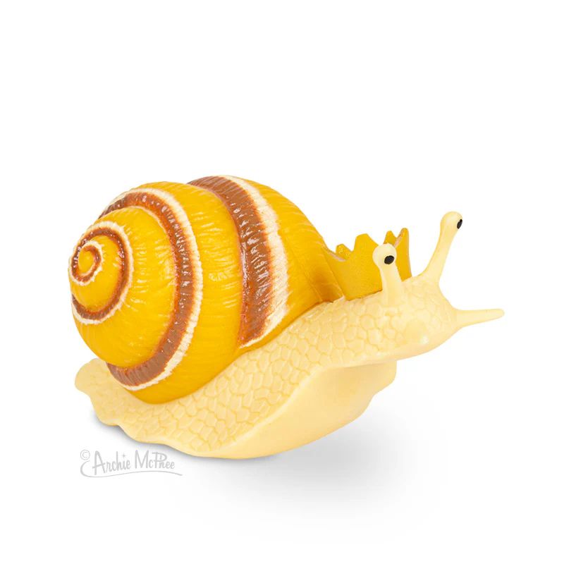 A whimsical snail figurine with a yellow and brown spiral shell, wearing a small crown on its head.