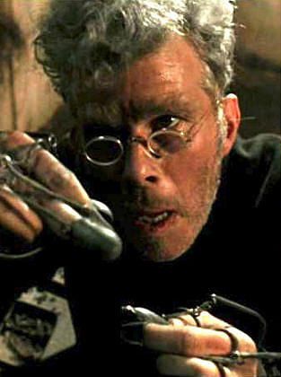 Tom Waits eating flies in Francis Ford Coppolas Dracula 

A grey haired man in round rimmed Victorian glasses hold something between his fingers. He wears wired braces on his hands. 
