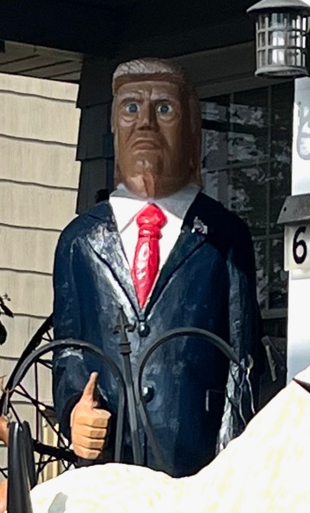 A close up of the sculpture of DJT, which is now part of the weird lawn display. It is weird and creepy AF. 