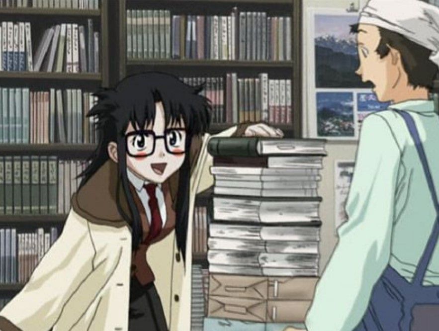 a woman with a huge stack of books