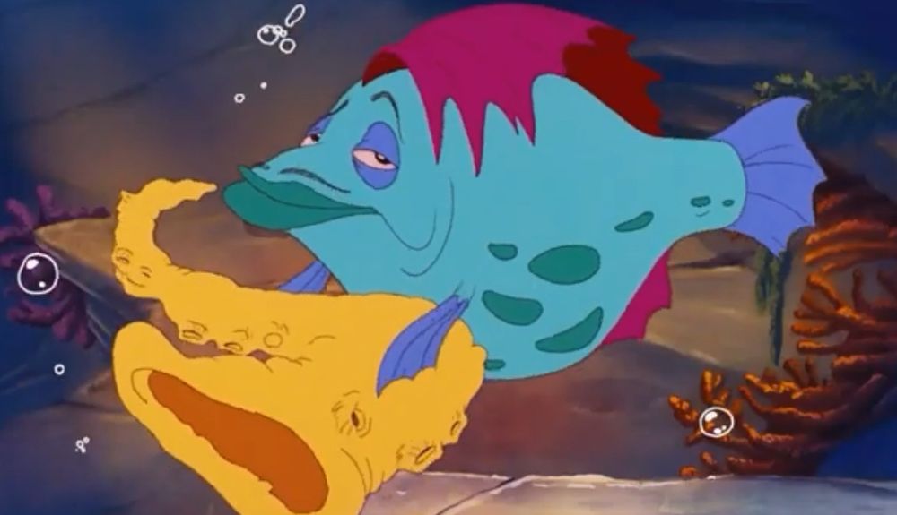 Cartoon fish playing a shell saxophone 