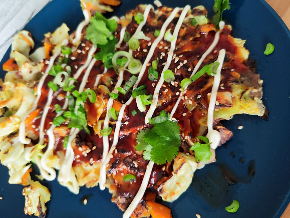 Self made Okonomiyaki from scratch, garnished with spring onion and coriander.