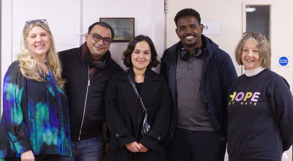 A photo showing five people smiling, likely organisers and attendees. Nadia Whittome MP is at the centre.