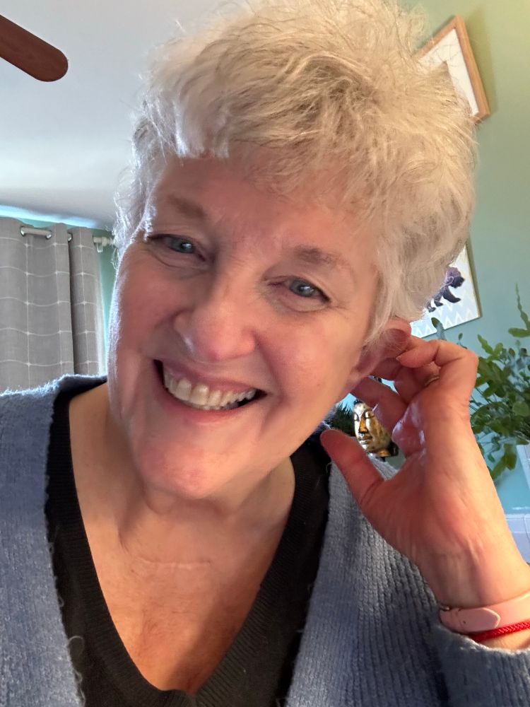 Devastatingly attractive older woman with white hair and blue eyes.