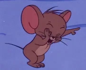 jerry from tom and jerry is yawning and pointing at something .