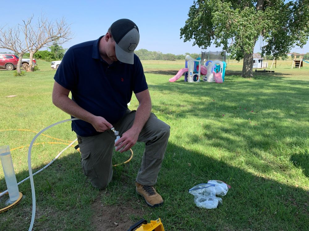 Student sampling a domestic water well