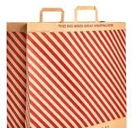 A large brown paper bag with diagonal red stripes and lettering indicating it can be turned into wrapping paper
