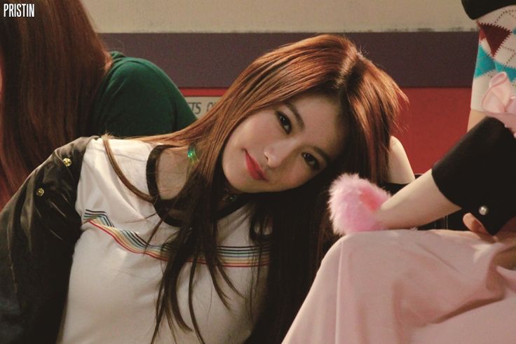 Photo of Yaebin (Rena) looking at the camera while leaning to the side on something.