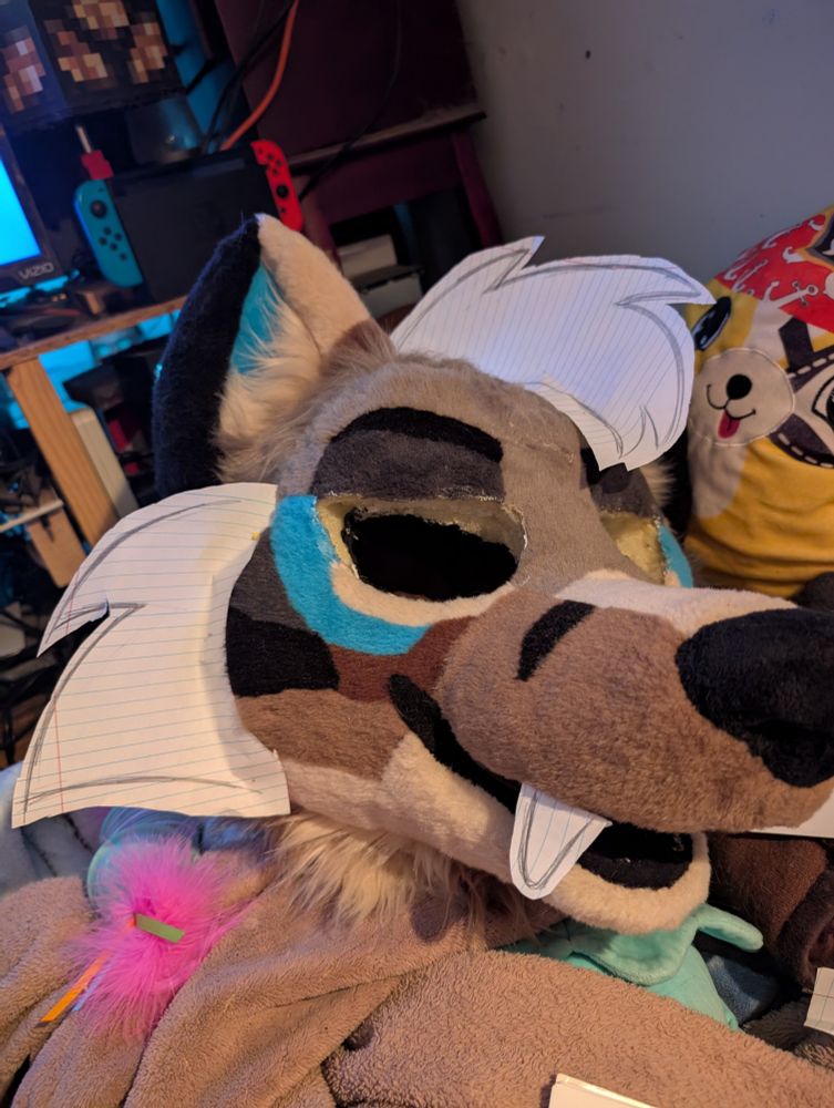 my fursuit with cheek, hair and teeth patterns pinned to him