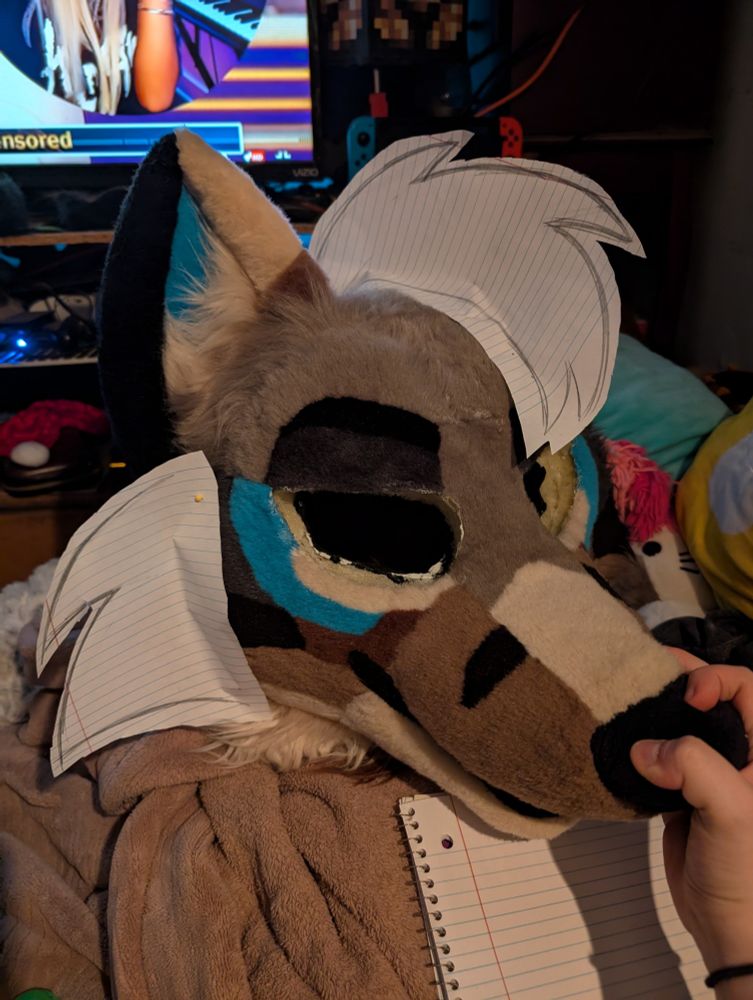 my fursuit with cheek and hair patterns pinned to him