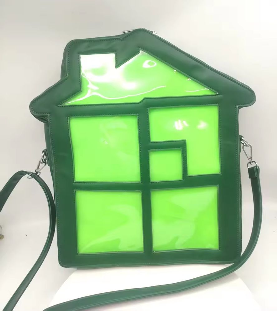 An image of a green ita bag in the shape of the Sburb logo