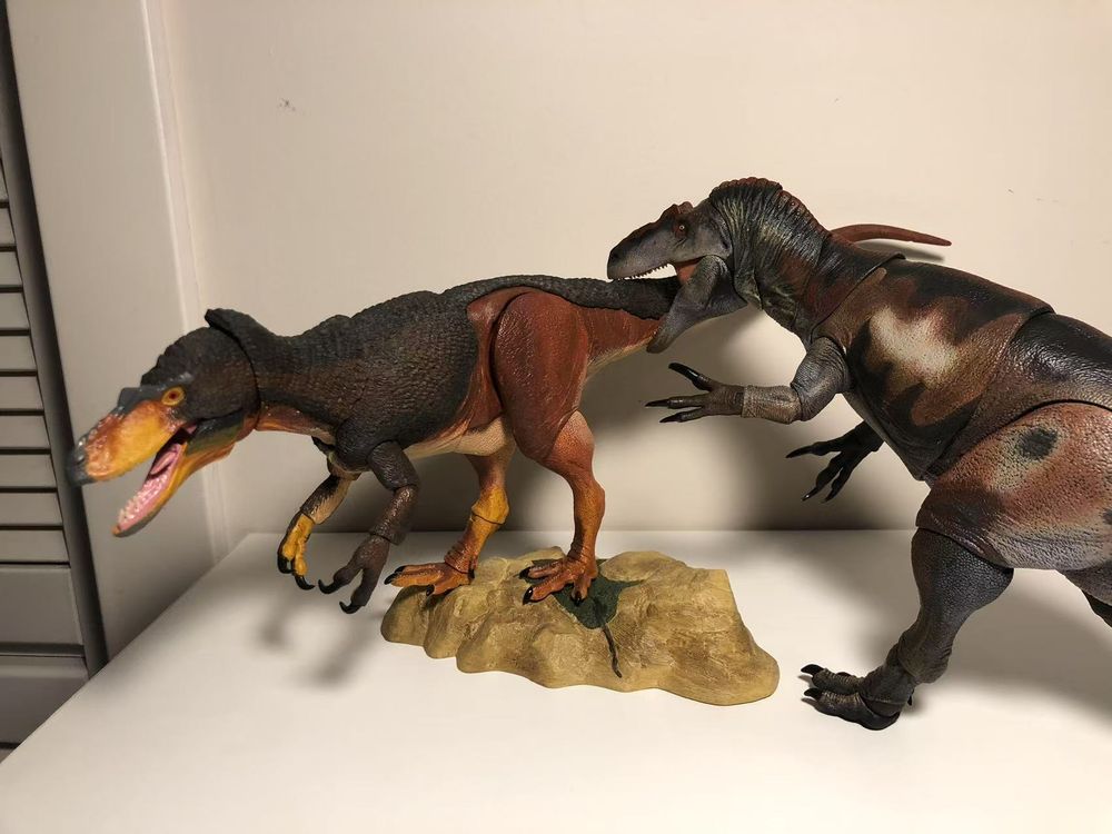 The beasts of the mesozoic dryptosaurus figure is posed somewhat statically in the left of frame with its mouth open, as the allosaurus figure is posed bounding forward and "biting" on its tail. 