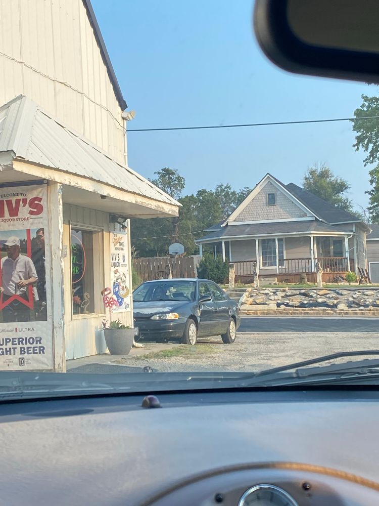 photo of a parked car with a cardboard cutout of jason momoa in the passenger seat