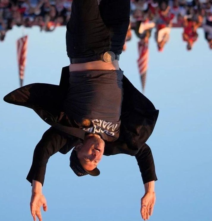 A photograph of Elon Musk upside down.