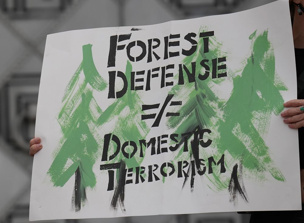 A sign reading "Forest defense does not equal domestic terrorism"