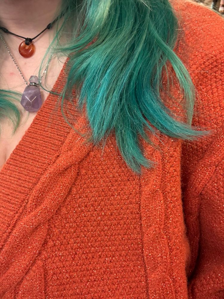 orange showgirl cardigan with teal green hair