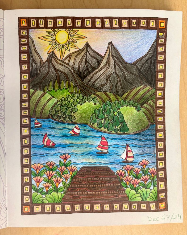 Photo of a completed page from an adult coloring book. Image is of a lake, mountains, and sunset with a swimming dock in the foreground. It is colored with pencil crayons. 