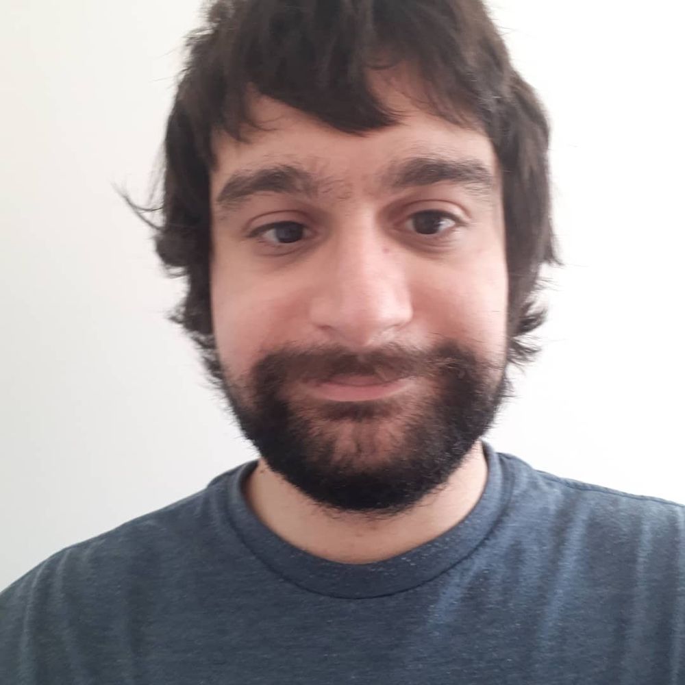 Matt smiling and with long hair