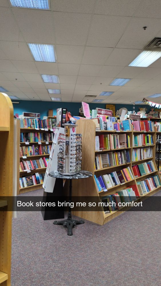 Picture shows rows of books with text on top that reads "Book stores bring me so much comfort"