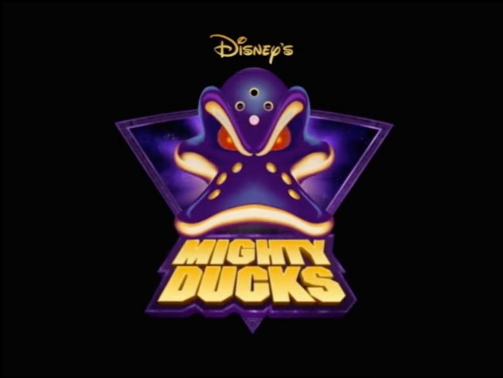 The logo for Mighty Ducks the Animated Series. It has a hockey mask in the shape of a duck's bill 