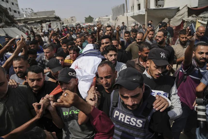 Palestinians carry the body of Al Jazeera reporter Anas Al-Sharif, who, along with other journalists, was killed in an Israeli airstrike, during his funeral outside Gaza City's Shifa hospital complex on August 11. Jehad Alshrafi/AP