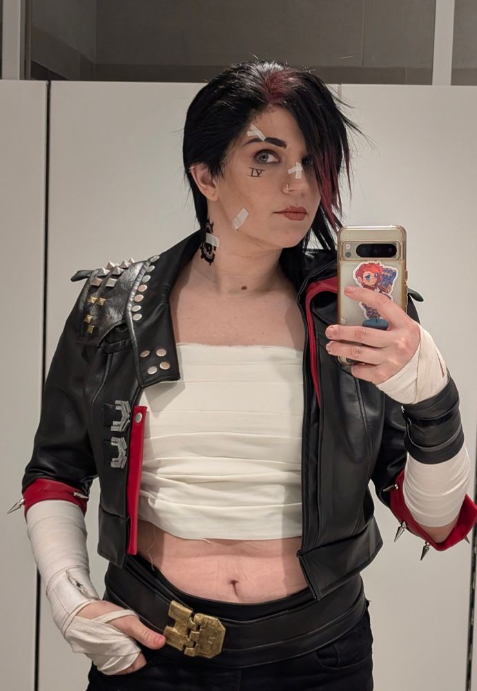 Mirror selfies of me in my pit fighter vi cosplay. I'm looking off camera to the viewers left with my hand in my pocket 