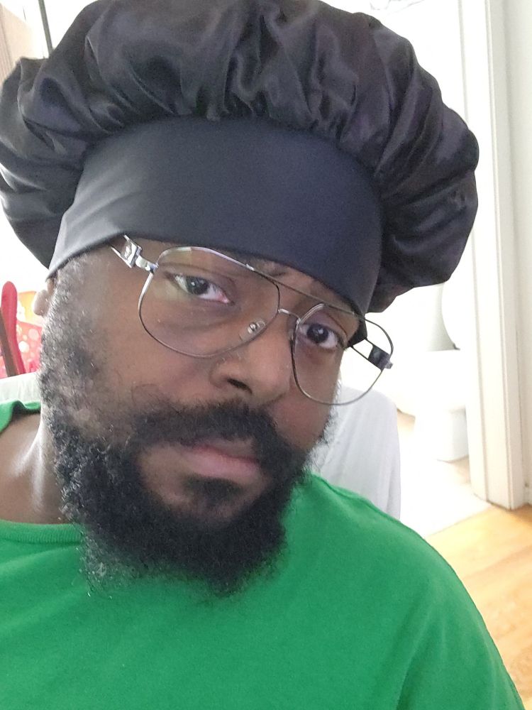 Me with a concerned look, glasses, and a bonnet similar to a popular meme.