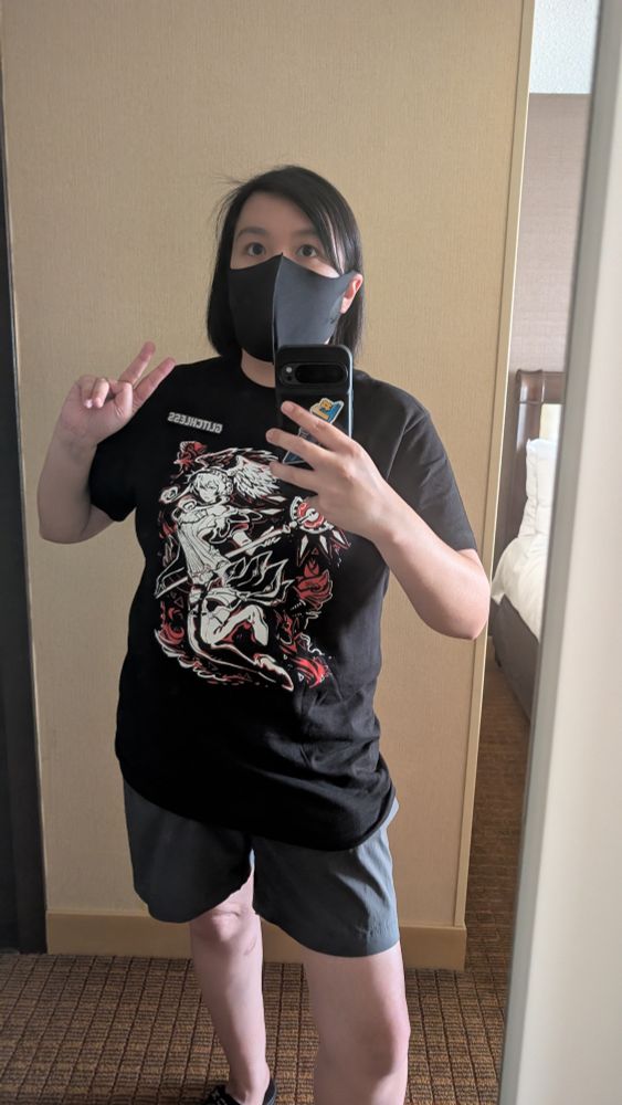 Sanjan selfie in the mirror with a Xenoblade shirt and a "Glitchless" pin