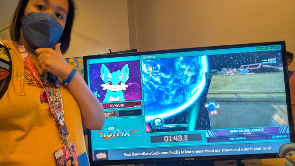Sanjan taking a selfie next to the Hotfix table at SGDQ 2025