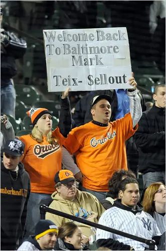 Orioles fans holding up signs calling Teixera a sellout 