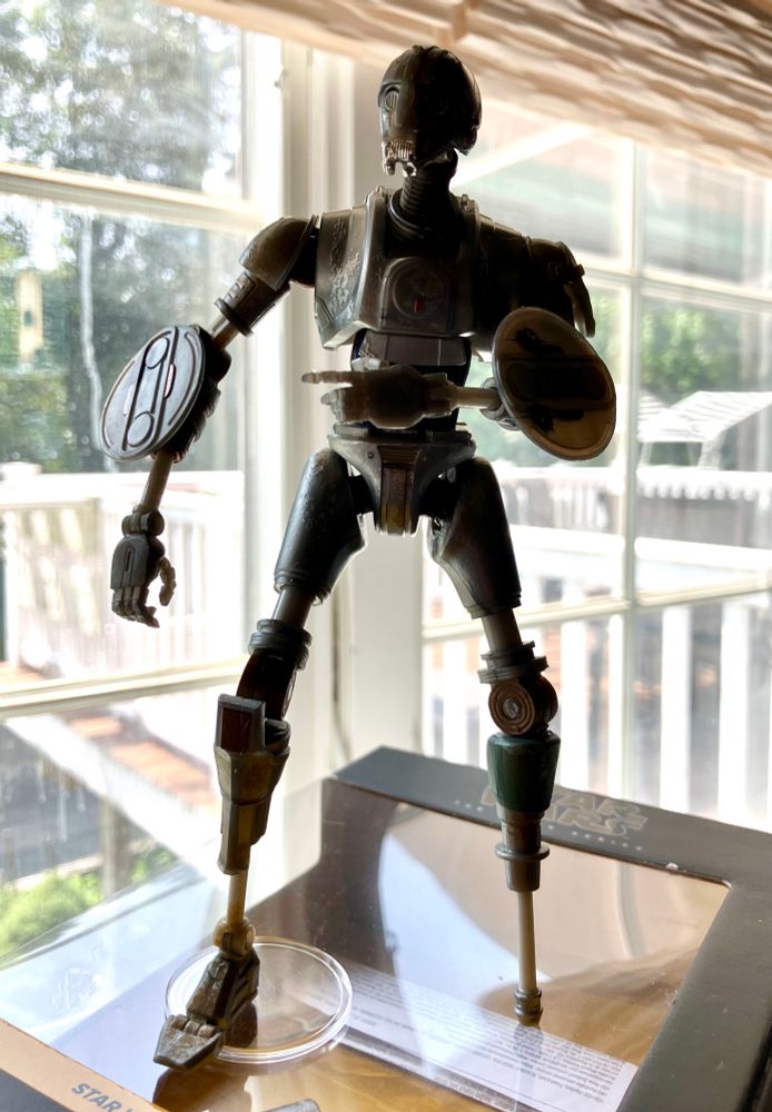 The SM-33 figure fully extended posed on its box.  It’s considerably taller.