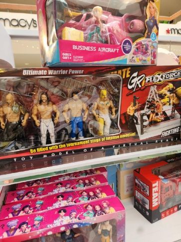 Knock-Off figures of The Rock, Seth Rollins, AJ Styles, and Rey Mysterio (Jr) marketed as ULTIMATE WARRIOR POWER