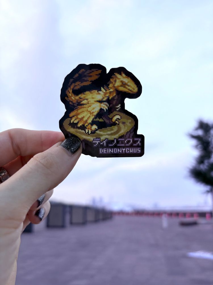 A deinonychus pixel art sticker backlit on a pier.
