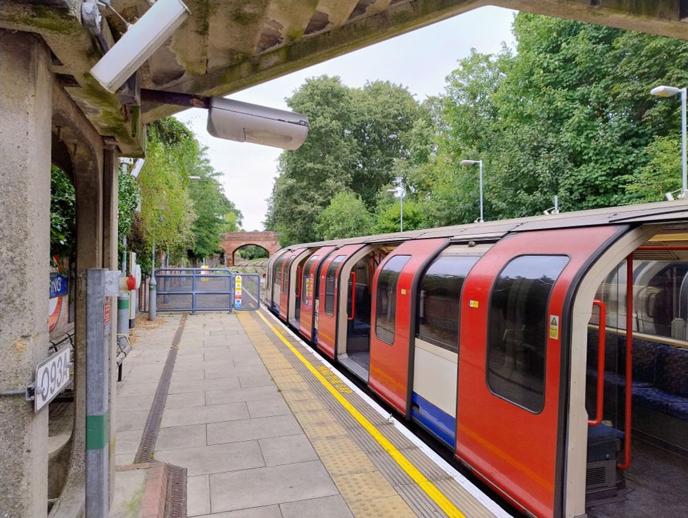 A picture of a Central Line tube train at Epping station, looking in the distance towards the former line to Ongar.