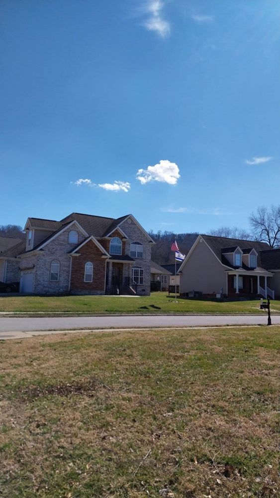 One little cloud over a house in my neighborhood. Very blue sky on a sunny day.