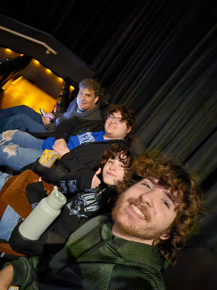 Selfie of me and three kids waiting for movie to start.