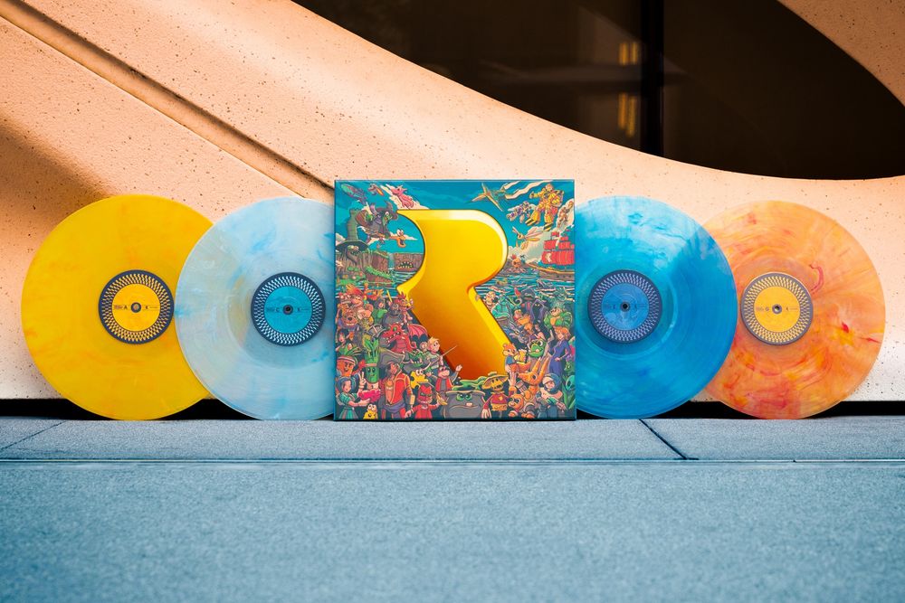 A vinyl set of four discs in yellow, orange and two shades of blue. The vinyl sleeve has a large yellow Rare logo set among artwork of a huge number of characters from the studio's games.